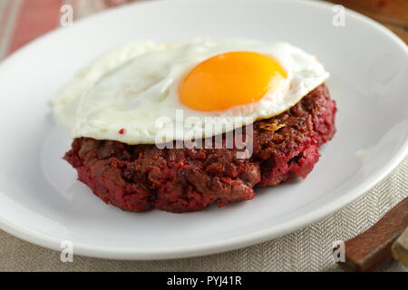 Svedese hamburger di manzo Biff a la Lindstrom con uovo fritto Foto Stock