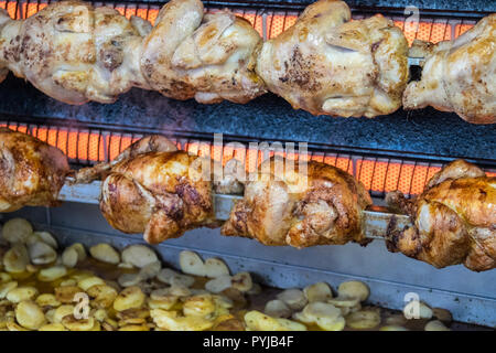 Pollo,polli,essendo,,arrosto con,chips,patate,essendo,cotto,fritto,a,gocciolamento,succhi di frutta, succhi di frutta,Esperaza,Domenica,mercato,Aude,sud,d,Francia,francese,cibo Foto Stock