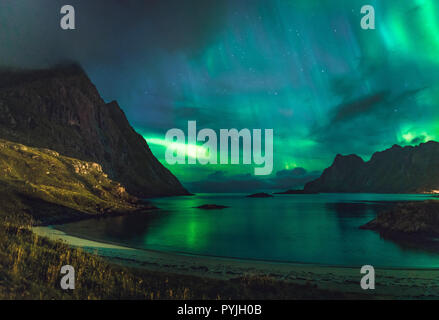 Aurora sulla spiaggia sabbiosa haukland, Kvalvika e Skagsanden con pietre in Norvegia, Isole Lofoten. Luci del nord in isole Lofoten in Norvegia. Stellato. s Foto Stock