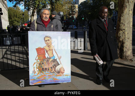 A Downing Street, Londra, Regno Unito. 29 ott 2018. Artista Kaya Mar con uno dei suoi dipinti raffiguranti il Cancelliere dello Scacchiere Philip Hammond e del Primo ministro britannico in una situazione Brexit sul giorno di bilancio, Downing Street. Credito: Dinendra Haria/Alamy Live News Foto Stock