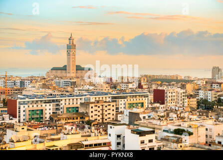 Vista sulla città di Casablanca, Marocco, durante l ora d'oro al mattino presto con la moschea di Hassan II e il mare sullo sfondo. Foto Stock