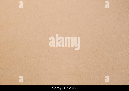 La coperta di pelliccia arancione in tessuto di pile. Una texture di sfondo di luce arancione peluche morbido materiale in vello Foto Stock