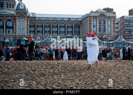 SCHEVENINGEN, 1 gennaio 2018 - giovane congrats gli uni con gli altri per aver realizzato il nuovo anno di immergersi in un gelido nord acqua di mare Foto Stock