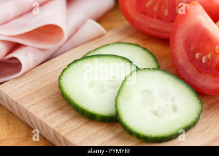 Cetriolo affettato ha vinto tagliere con prosciutto e pomodoro dietro. Foto Stock