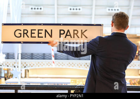 Olympia Exhibition Centre di Londra, UK, 29 ott 2018. Un rappresentante di Malby mappe detiene un originale stazione della metropolitana di Green Park segno che è in vendita presso la fiera. L'inverno arte e antiquariato a Olympia London dispone di 70 top i concessionari del Regno Unito e sarà eseguito 30 ott-nov 4. Credito: Imageplotter News e sport/Alamy Live News Foto Stock