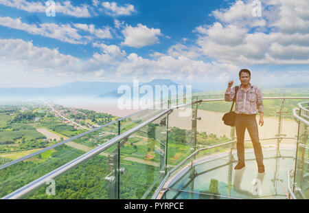 Soft focus l'uomo stand alla skywalk tailandese, il bellissimo cielo e cloud a fiume Mekong, confine internazionale tra il quartiere Sangkhom Nong Khai provi Foto Stock