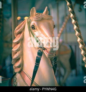 Testa di cavallo in un Merry Go Round su una storica summer luna park con vintage instagram look. Concetto di divertimento Foto Stock