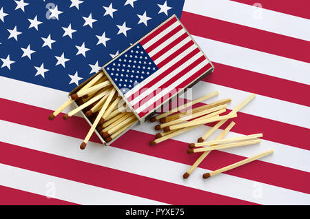 Stati Uniti d'America flag è mostrato su un open matchbox, da cui diversi corrisponde a caduta e giace su di una bandiera di grandi dimensioni. Foto Stock