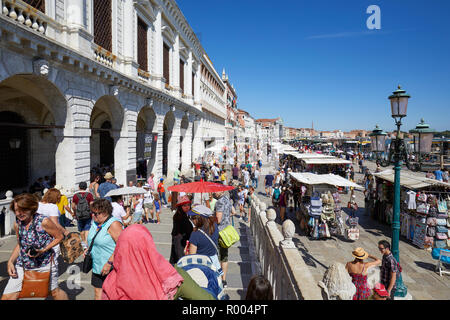 Venezia, Italia - 13 agosto 2017: Cittadini e turisti a Venezia a piedi con ombrelli sotto il sole vicino a piazza San Marco in una soleggiata giornata estiva in Ita Foto Stock