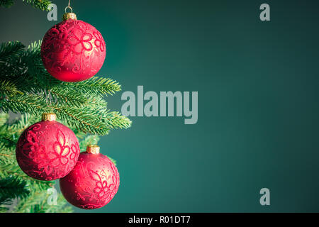 Verde scuro dello sfondo di Natale con le palle rosse. Foto Stock