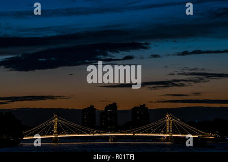 Londra, Regno Unito. Il 31 ottobre, 2018. Il sole tramonta dietro Albert bridge e Porto di Chelsea. Credito: Guy Bell/Alamy Live News Foto Stock