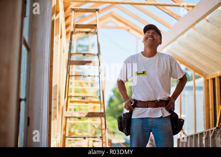 Persone di mezza età builder lavorando sull'inquadratura in legno di un edificio. Foto Stock