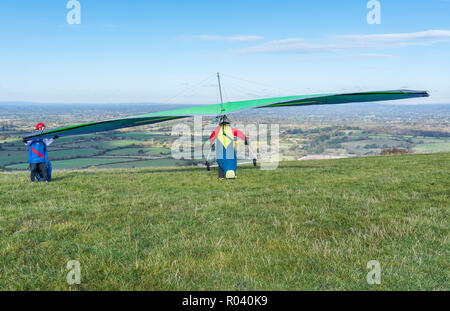 Uomo di decollare da colline su un deltaplano a Devil's Dyke sulla South Downs in East Sussex, Inghilterra, Regno Unito. Foto Stock