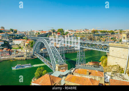 Paesaggio urbano con la barca turistica sotto il fiume Douro. Lo skyline di antenna di Dom Luis I Bridge, Ribeira Waterfront e porto da Vila Nova de Gaia, Porto, Portogallo. Foto Stock