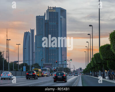 Abu Dhabi il traffico della città, Etihad Tower, nazione e Torre sede Adnoc contro mody sky Foto Stock