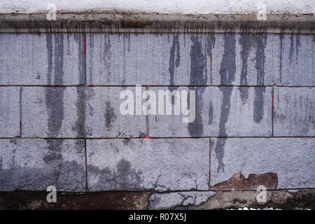 Grigio Grigio grunge muro di cemento con verticali fluente macchie di umido. Foto Stock