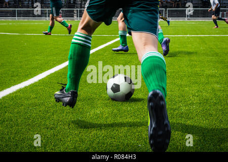 I giocatori di calcio che giocano a calcio Foto Stock