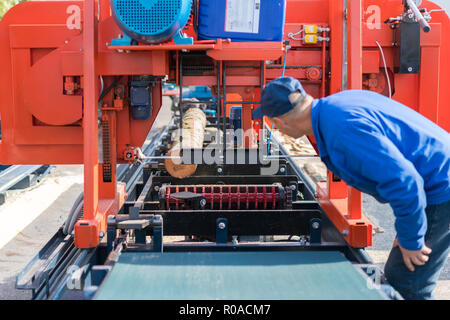 Lavoratore premendo i pulsanti su macchina CNC scheda di controllo in fabbrica. Lavoratore lavora a woodworking enterprise Foto Stock