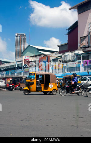 Un Pass App taxi che può essere prenotato per telefono cellulare è la guida su una strada di città adiacente al mercato Orussey in Phnom Penh Cambogia. Foto Stock
