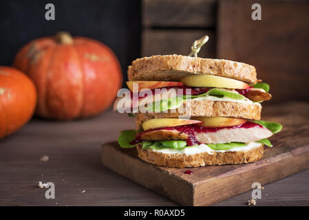 La Turchia o pollo avanzi di sandwich con ripieno e salsa di mirtilli. Appena sfornati dal giorno del Ringraziamento o tacchino di Natale gli avanzi sul crusty wholemea Foto Stock