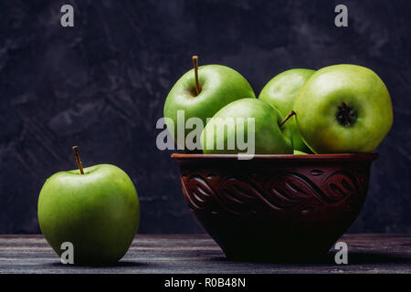 Le mele in un vaso di argilla mature frutta verde Foto Stock