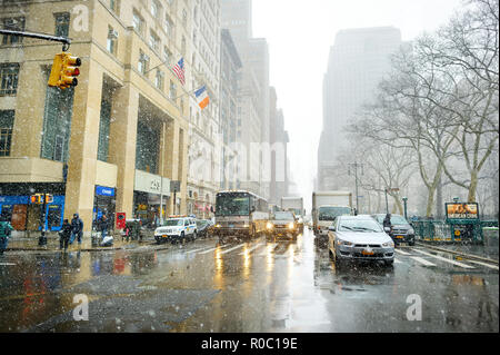 NEW YORK - MARZO 19, 2015: auto, taxi e gente correre su strade trafficate del centro cittadino di Manhattan durante la massiccia caduta di neve. Nevoso inverno meteo in N Foto Stock