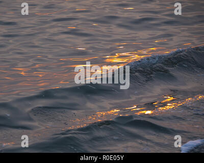 I riflessi del tramonto su wave Foto Stock