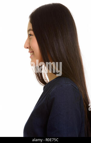 Vista di profilo di giovani asiatici felice ragazza sorridente Foto Stock