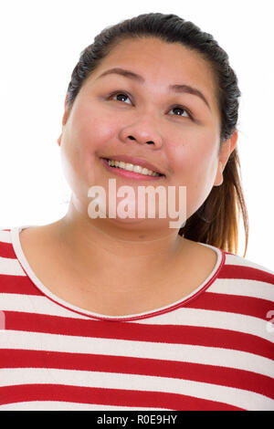 Volto del giovane felice grasso donna asiatica sorridere mentre il pensiero e l Foto Stock