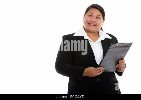 Riflessivo giovani felici fat Asian imprenditrice sorridente e looki Foto Stock