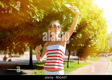 Ragazza giovane prendere selfie da mani con telefono sul giorno di estate Foto Stock