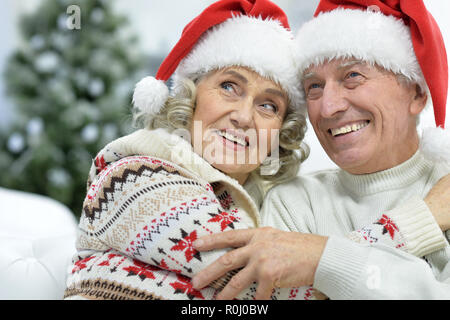 Ritratto di coppia senior in cappelli di Babbo Natale Foto Stock