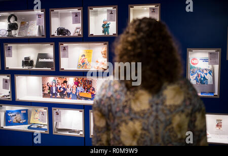 Berlino, Germania. 05 Nov, 2018. Una donna sta durante un'anteprima della mostra "Jahrgang '89 - Die Kinder der Wende' al GDR Museum nel quartiere Mitte. Il nuovo gabinetto mostra rimarrà aperta per l anniversario della caduta del muro di Berlino, 09.11.2018. Fino al 28.02.2019, la piccola esposizione mostrerà le biografie e presenta dell'ultima annata completa nato nella RDT come pure gli oggetti su eventi importanti dell'anno in 26 vetrine. (A 'Nuova Fiera di Berlino: nato 1989 - i bambini della caduta del Muro" dal 06.11.2018) Credito: Bernd von Jutrczenka/dpa/Alamy Live News Foto Stock