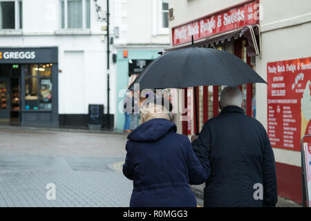 Tenby, Pembrokeshire, West Wales, Regno Unito. 6 novembre 2018. Regno Unito meteo: Heavy Rain e gales presso la costa di oggi. Un paio di riparo dalla pioggia. Credito: Andrew Bartlett/Alamy Live News Foto Stock