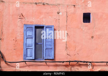 Finestra blu sulla parete rosa. Foto Stock