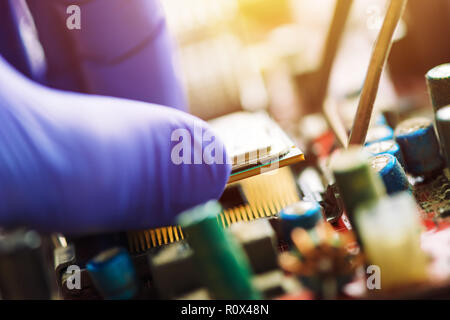 Computer forensics investigator installazione vecchia CPU sulla scheda madre del computer per recuperare la macchina e i dati persi, la stretta di mano Foto Stock