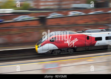 Virgin Trains treno pendolino panoramiche con motion blur come esso si discosta Preston stazione ferroviaria Foto Stock