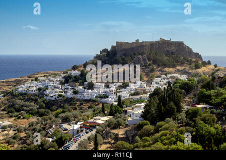 La storica città di Lindos,con le sue pareti bianche e l'acropoli medioevali che lo sovrasta. Foto Stock