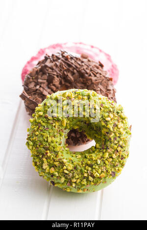 Dolce ciambelle vetrate sul tavolo bianco. Foto Stock