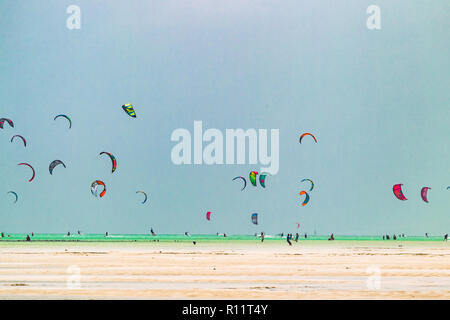 Kiteboarding vicino al villaggio di Jambiani. Zanzibar è uno dei luoghi migliori per il kitesurf vacanze. Calda acqua poco profonda e costante vento. Foto Stock