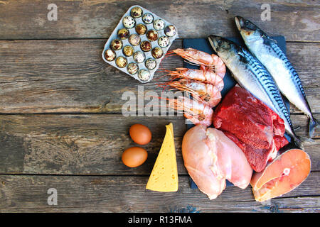 Il cibo sano di origine animale sul vecchio sfondo di legno. Concetto di nutrizione adeguata. Vista dall'alto. Lay piatto. Foto Stock