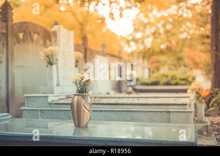 Tombe con pietre grave in un cimitero in autunno. Il memorial day Foto Stock