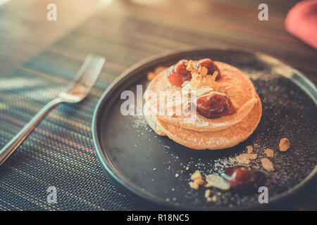 Frittelle con le bacche e sciroppo d'acero. Elegante e di lusso prima colazione Foto Stock