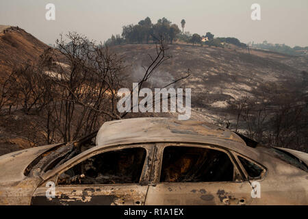 Malibu, California, USA. Decimo Nov, 2018. Un veicolo e di montagna lungo la Pacific Coast Highway furono bruciati durante la Woolsey Fire in Malibu, California. La Woolsey fire raddoppiato di volume durante la notte con 70.000 acri bruciato costringendo quasi 95.000 residenti a evacuare le loro case di Los Angeles e Ventura contee come del sabato mattina secondo la Cal Fire. Credito: Joel Angelo Juarez/ZUMA filo/Alamy Live News Foto Stock