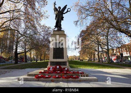 Londra, Regno Unito. - 11 Novembre 2018: il papavero ghirlande a sinistra al Hammersmith Memoriale di guerra su Shepherd's Bush Green sul centesimo anniversario dalla fine della Prima Guerra Mondiale. Credito: Kevin J. Frost/Alamy Live News Foto Stock