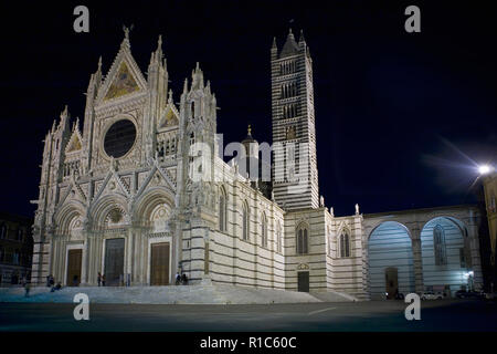 Elaborata facciata di Siena il Duomo illuminata di notte, Toscana, Italia Foto Stock