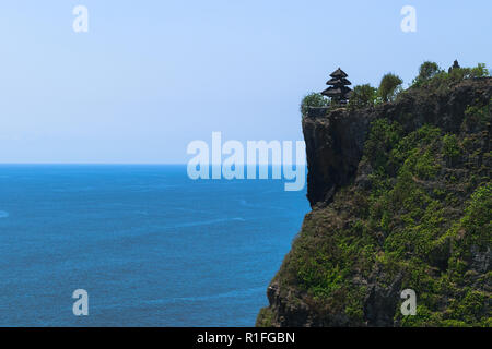 Pura luhur uluwatu tempio sulla scogliera con vista bellissima del blu oceano Indiano a Bali, in Indonesia Foto Stock