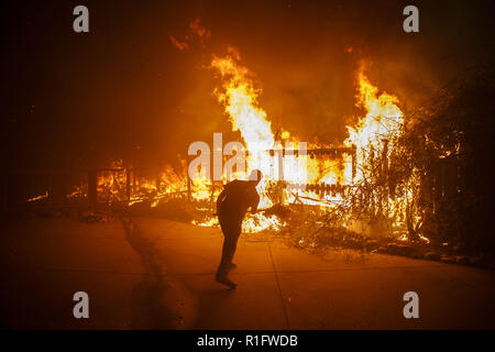 Malibu, California, USA. 9 Nov, 2018. Sarà Buckley usa una pala per cercare di spegnere le fiamme per salvare la sua casa in attesa per i vigili del fuoco per arrivare sul Dume unità dopo gli idranti è andato a secco di acqua durante la Woolsey Fire venerdì 9 novembre 2018 in Malibu, California © 2018 Patrick T. Fallon Credito: Patrick Fallon/ZUMA filo/Alamy Live News Foto Stock