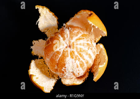 Mezza sbucciata mandarin su uno sfondo nero close-up 2018 Foto Stock