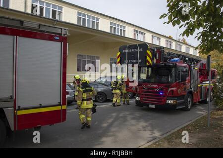 Stati Uniti Esercito vigili del fuoco civili dalla U.S. Army Garrison (USAG) Ansbach dimostrare evacuazione e salvataggio procedure al battaglione e quartier generale di brigata a Storck Baracks in Illesheim, Germania, 10 ottobre, 2018. La dimostrazione è parte del presidio di ricorrenza annuale per la prevenzione degli incendi e per la settimana. Foto Stock